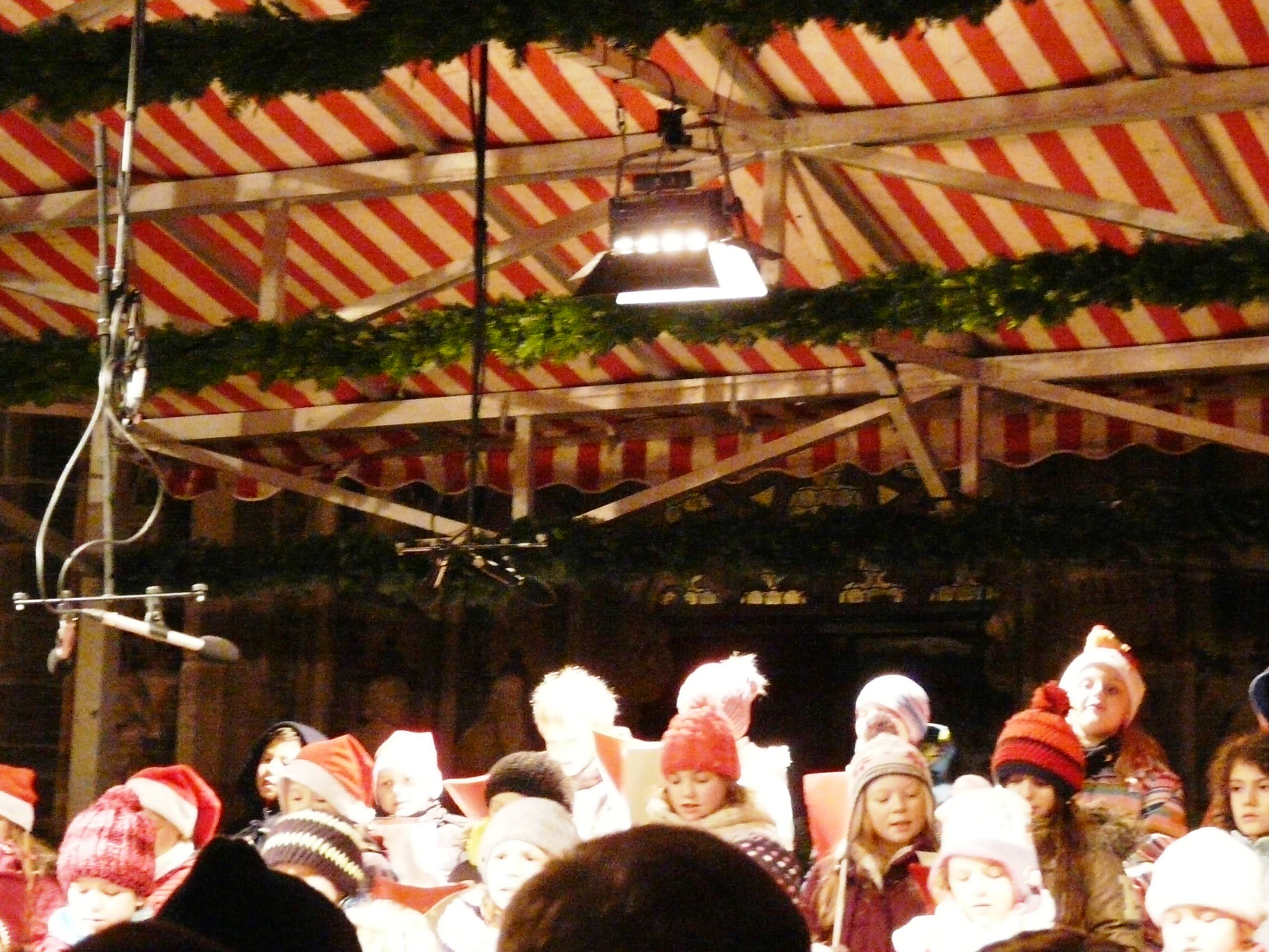 τα παιδια τραγουδουν χριστουγεννιατικα τραγουδια στη πλατεια Νυρεμβεργη..